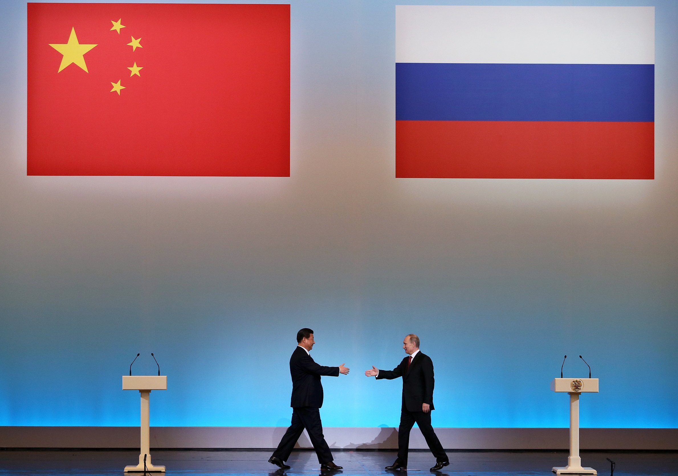 China's President Xi Jinping (L) is welcomed by his Russian counterpart Vladimir Putin (R) during the opening ceremony of "The Year of Chinese Tourism in Russia" in Moscow, on March 22, 2013.